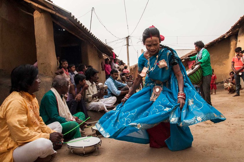 A women in blue saree is performing