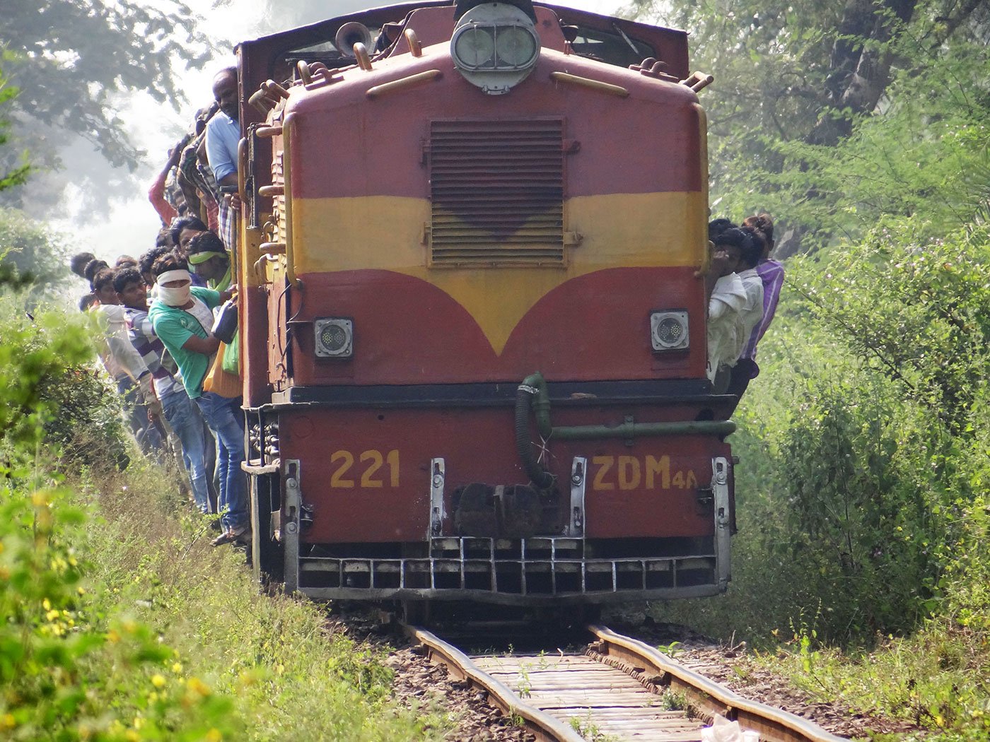 People hanging outside  Kendri to Dhamtari train