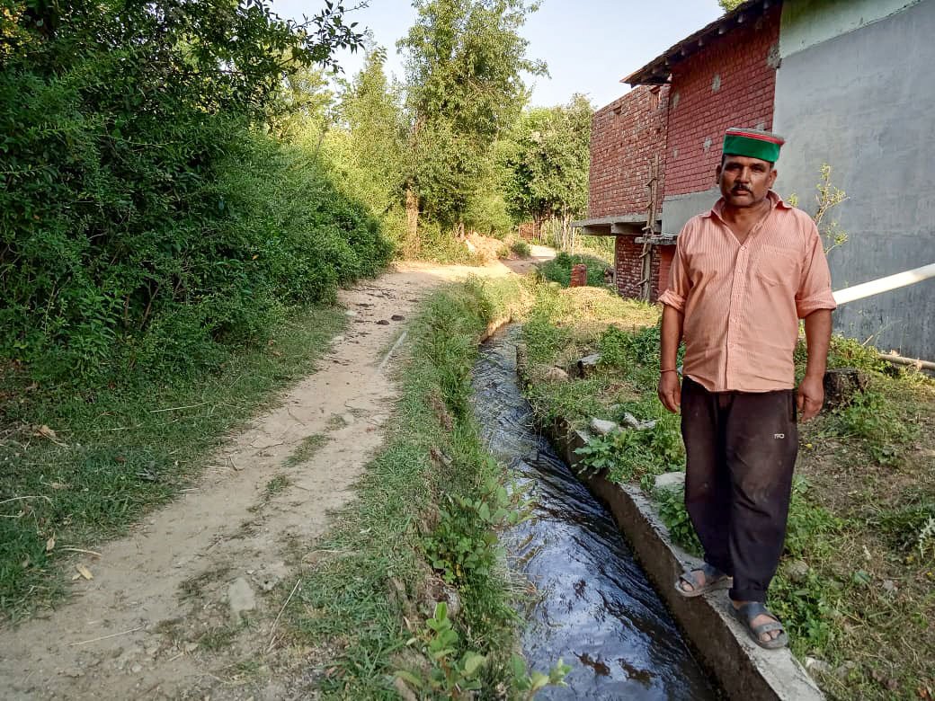 Joban Lal stands by the water canal