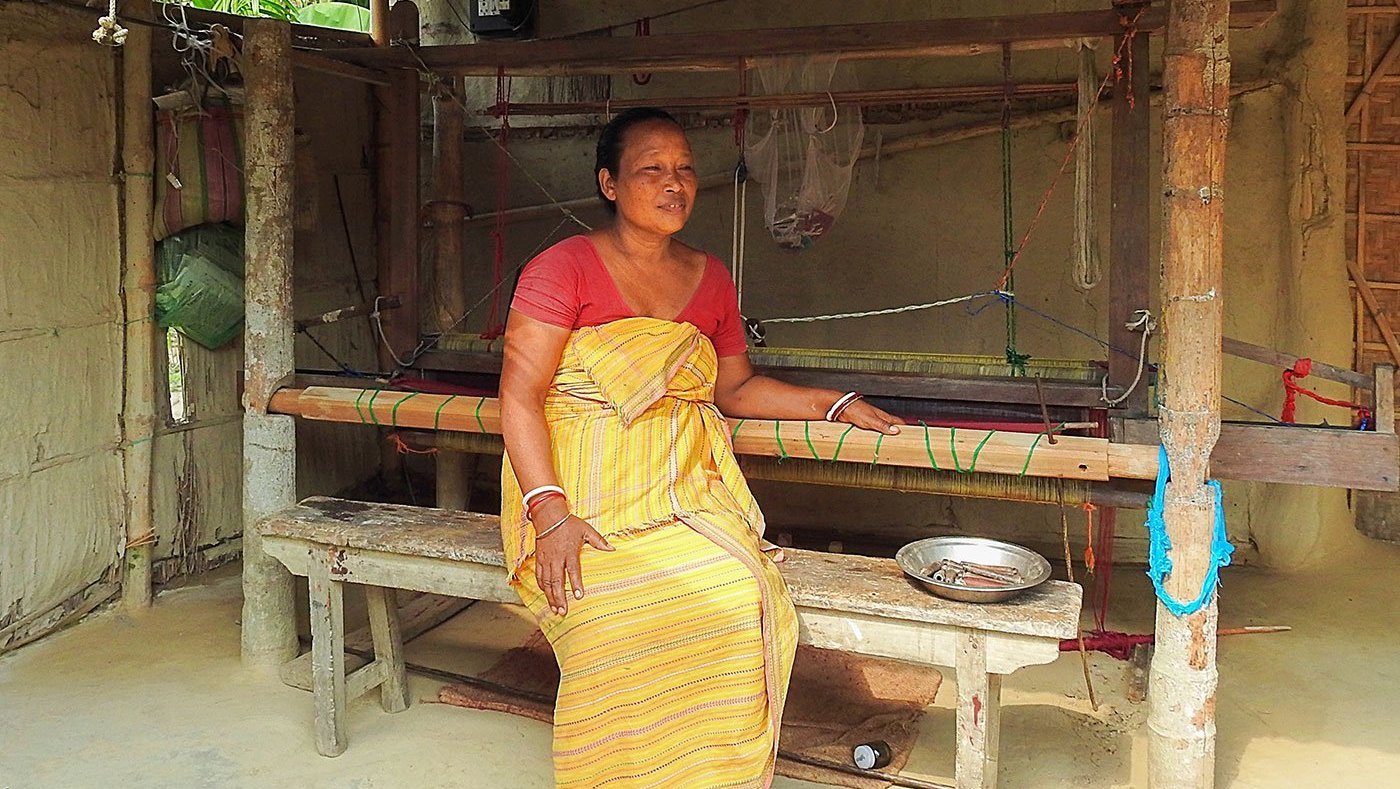 Woman sitting at the loom