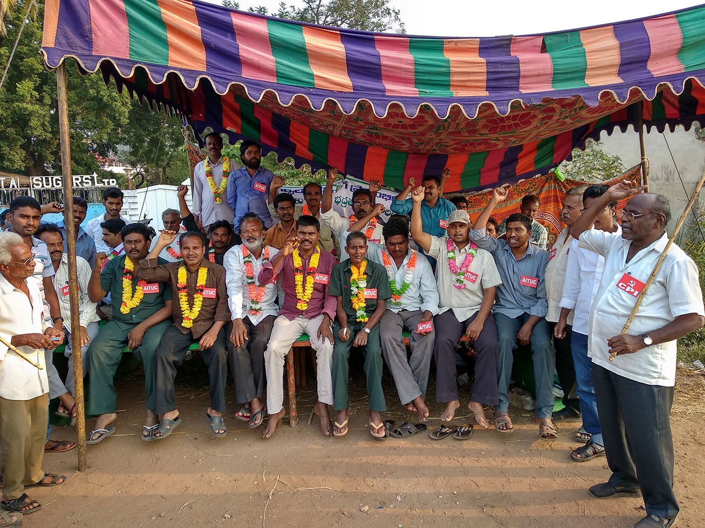 Workers sitting on a relay hunger strike in front of the sugar mills in a makeshift tent facing the Chennai Kolkata National Highway