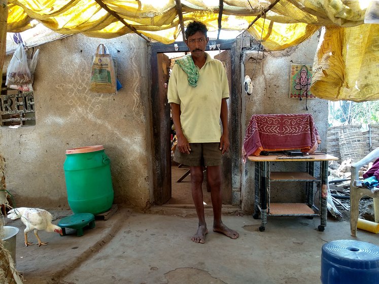 Bapiraju stands in front of his demolished house 