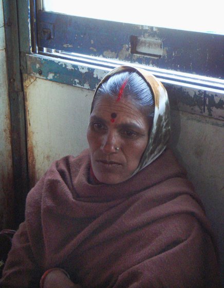 On the platform and in the train are more women like Buribai Nagpure (left) and Shakuntalabai Agashe (right), weary-eyed, hungry, half-asleep