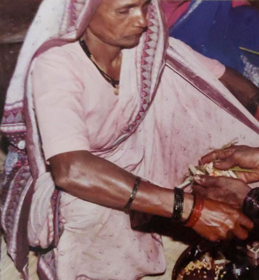 Left:  A haldi-kumkum function with Savitrabai Ubhe and others from her village (file photo). Right: Savitrabai receiving flowers at the event