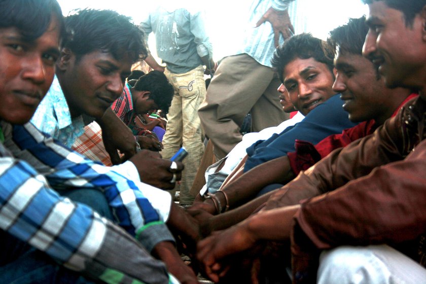 Young men wait for contractors at the labour naka in Udaipur. At least one male from most of the families in the district migrates for work (file photos)

