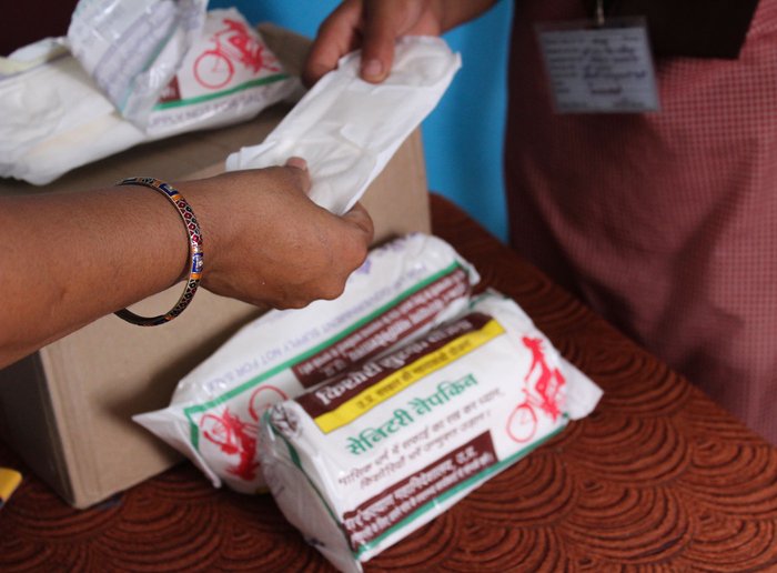 Before the lockdown: Nirasha Singh, principal of the Upper Primary School in Mawaiya village, Mirzapur district, distributing sanitary napkins to students

