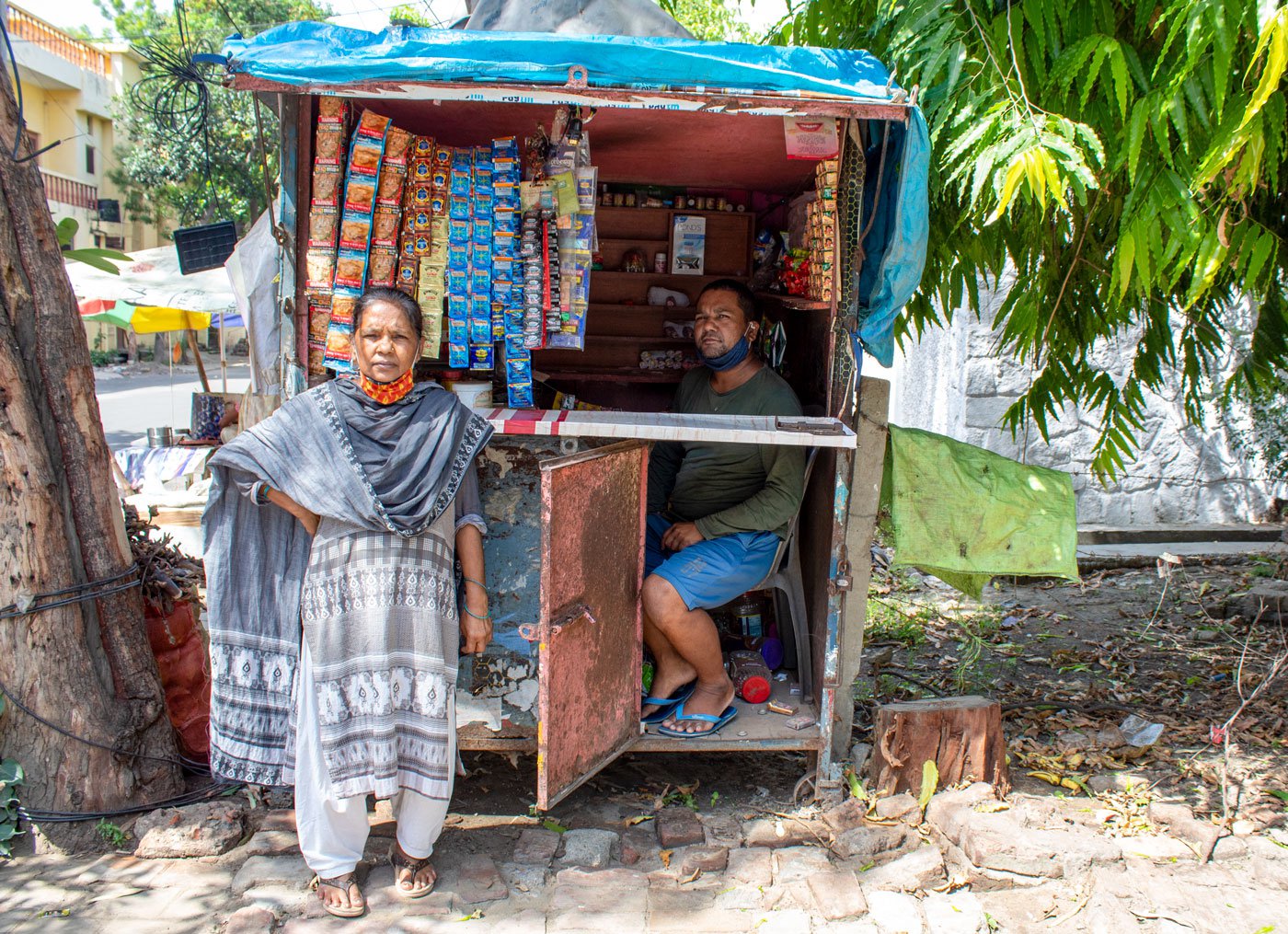 Ramvati with her son Rakesh Kumar at her husband Ram Saran’s kiosk: they disbelieve the ‘Covid-19 positive’ notation