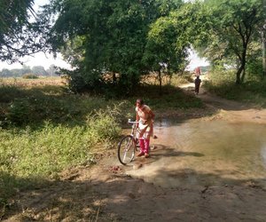 Girl paddling through puddles to reach school