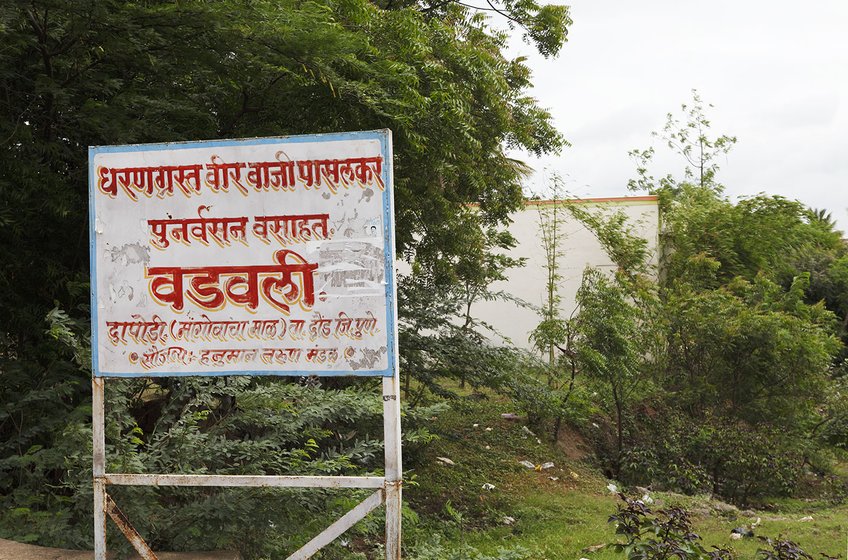 Left: A board announcing the resettlement of Sarubai's village Wadavali, which was submerged when the Warasgaon dam was built in`1994. Right: A few weeks ago, Sarubai's son asked her to leave his house; she now lives in this dilapidated hut at the entrance to the village