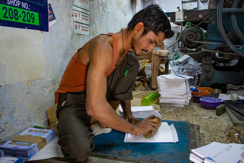 Left: Mohammad Asif Shaikh at Sonal Envelopes hitting the 'stone' on dhapa to create a fold.