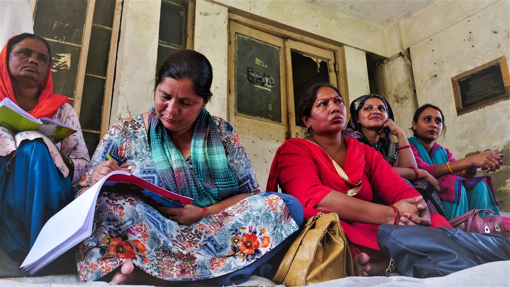 'We don’t even have time to sit on a hartal,' says Sunita Rani; at meetings, she notes down (right) the problems faced by co-workers 

