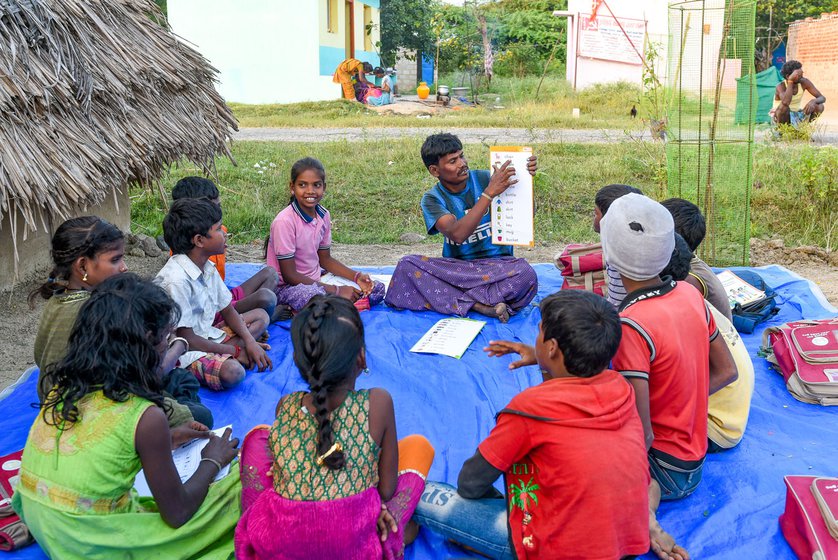 Most of the families in the single-steet Bangalamedu hamlet have accounts in a bank branch in K. G. Kandigai town. Right: Manigandan, who runs after-school classes, helps people in the hamlet with their bank-related work