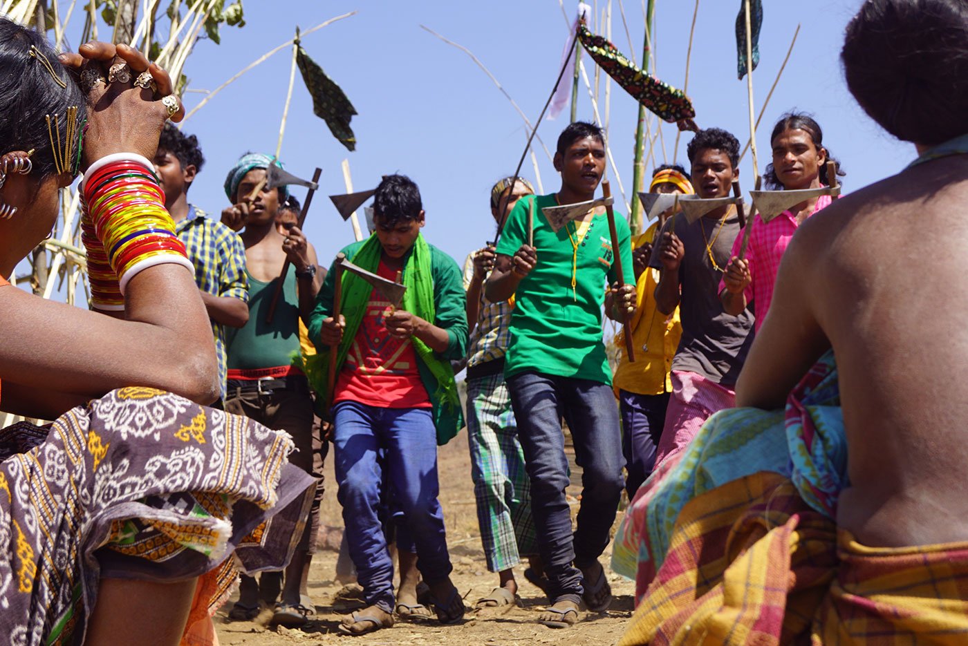 Tribal men dancing with their axes