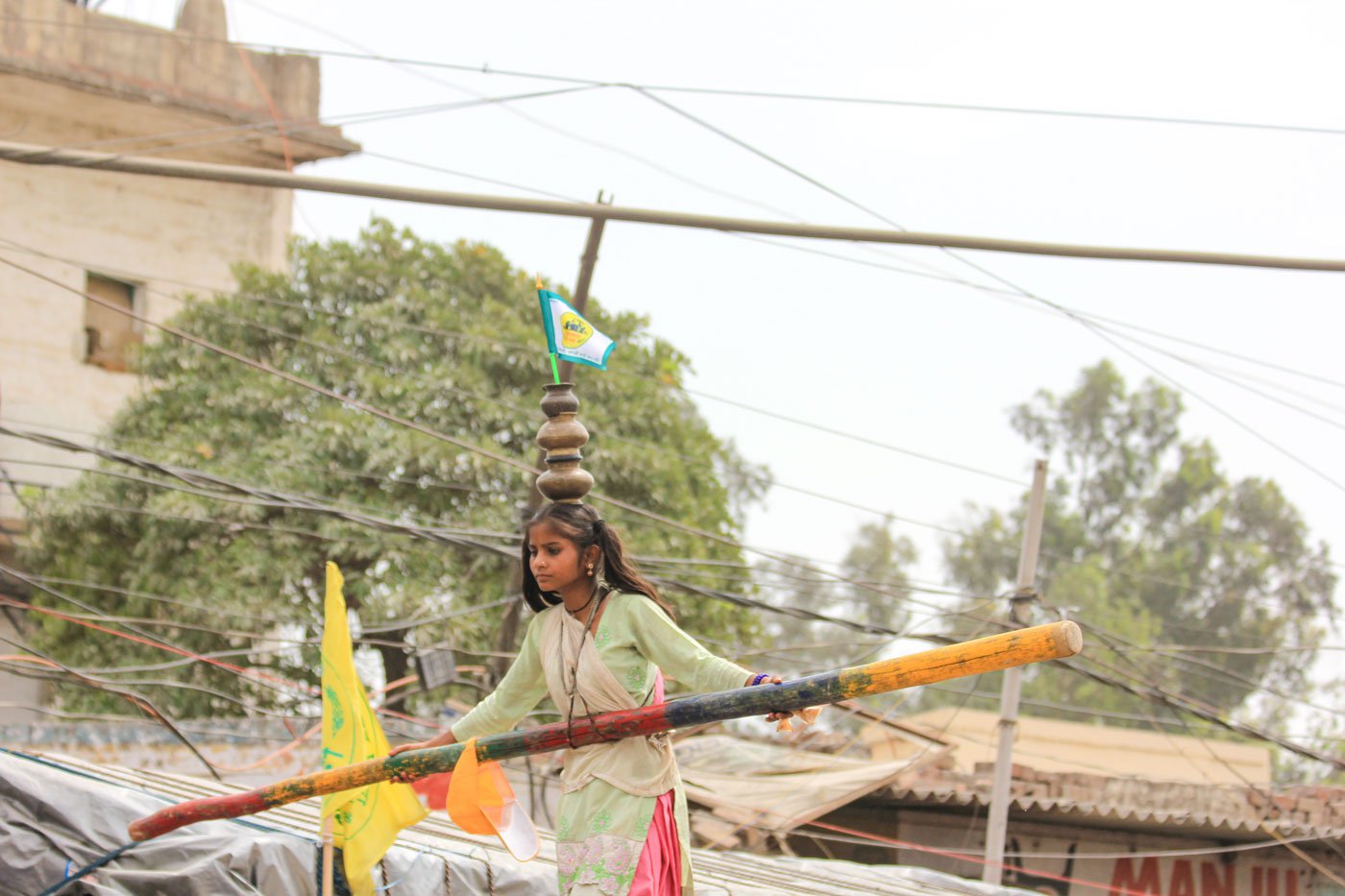 A flag fluttering on the pots atop Rani's head says, 'No Farmers, No Food'. It expresses the Nat family's solidarity with the protesting farmers