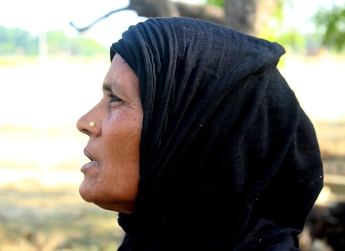 An angry Iddan waves her medical reports outside her home
