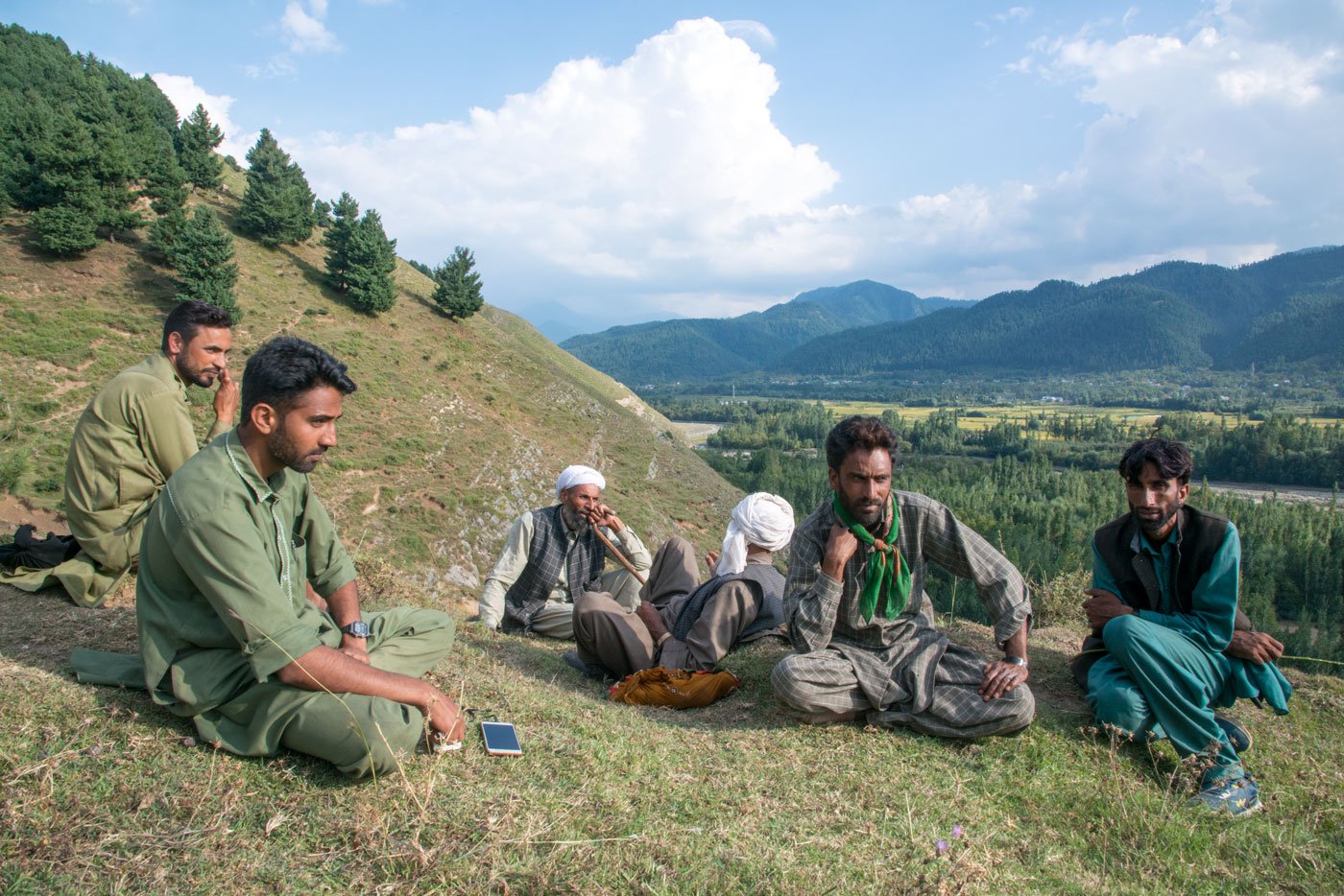 Shaukat Ali Kandal and Gulam Nabi Kandal with others in their group discussing the day's work