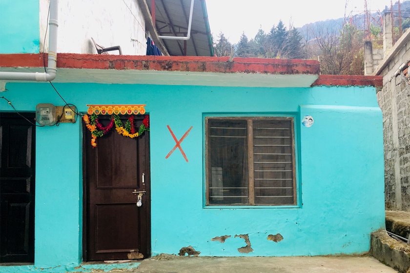 The red cross on a house identifies those homes that have been sealed by the administration and its residents evacuated