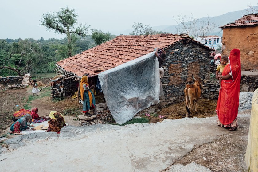 Left: Mukesh and Ramli at home in Baroliya.'We have to work even now,' says Ramli. Right: Women in Baroliya usually work at local construction sites (file photo)

