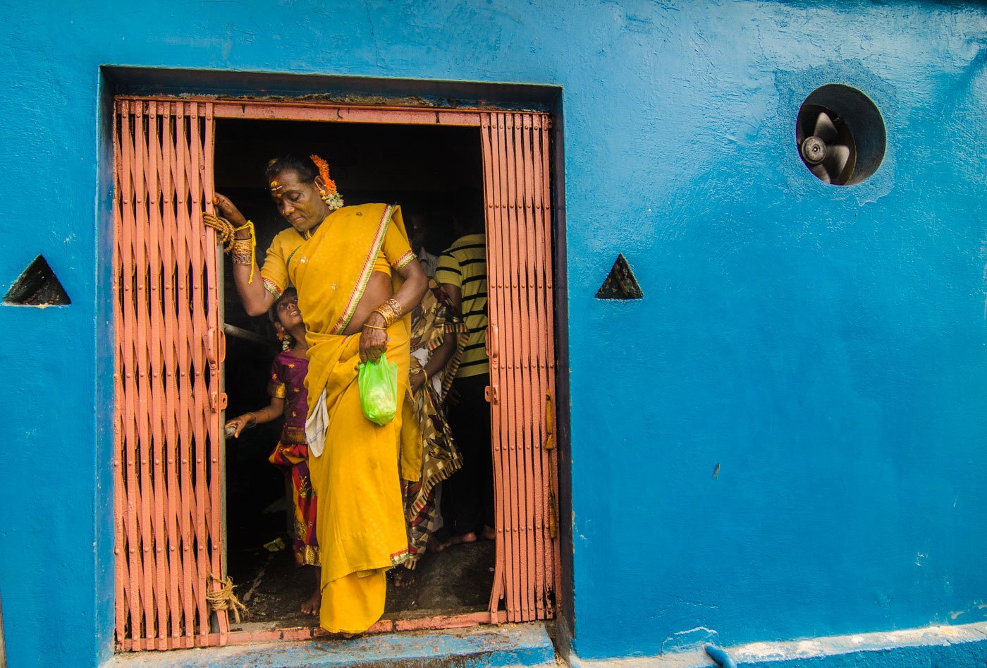 Married to her lord, an older aravani leaves the temple feeling content.