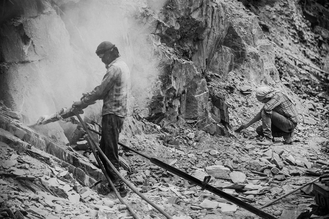 Man drilling into the mountainside in Ladakh for a road