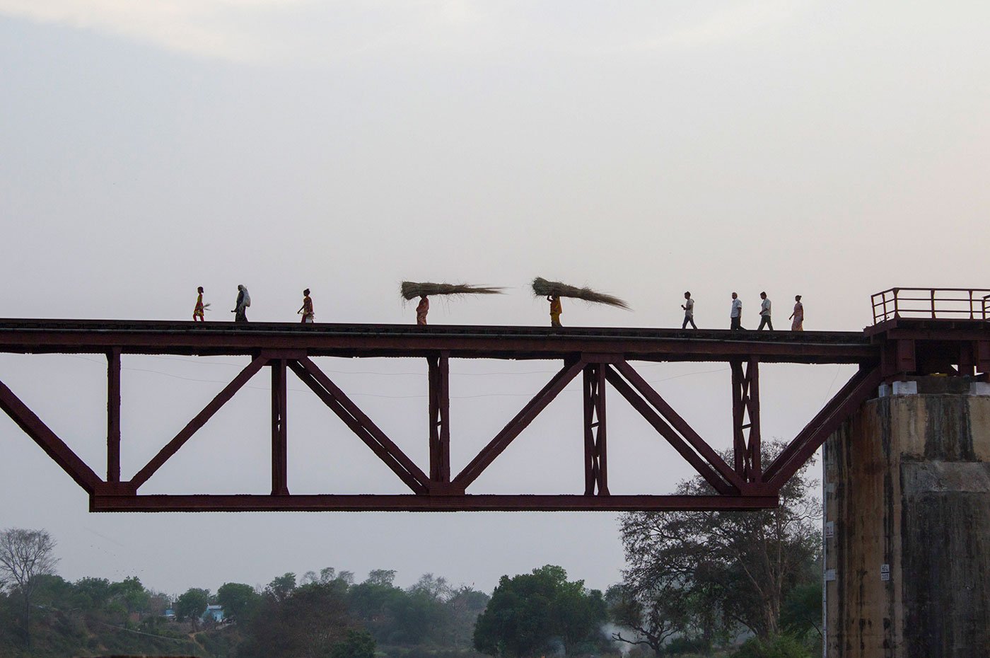 Carrying the firewood across rivers, roads and railways