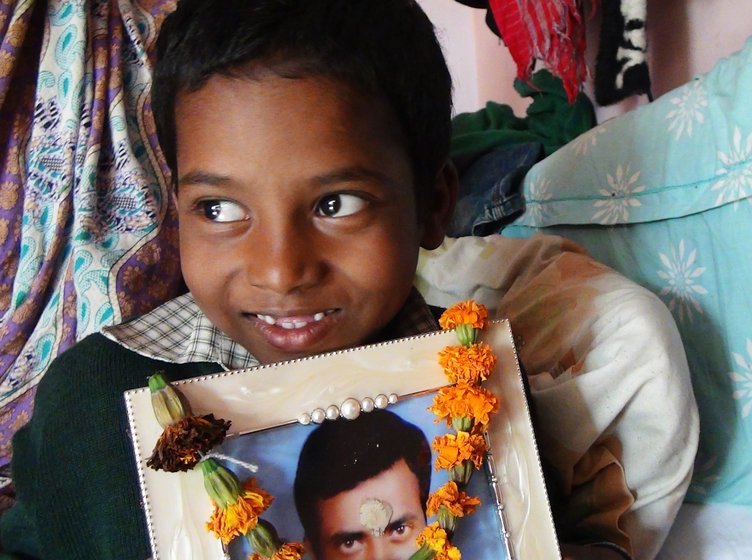 Left: Their son, Amit, 9, with his father's photograph: ' I will become an engineer and develop technology that will prevent humans cleaning gutters' Right: 'Caste matters',  says Putul. 'I cannot get my husband back. I want only that no one else should have to face this ordeal '