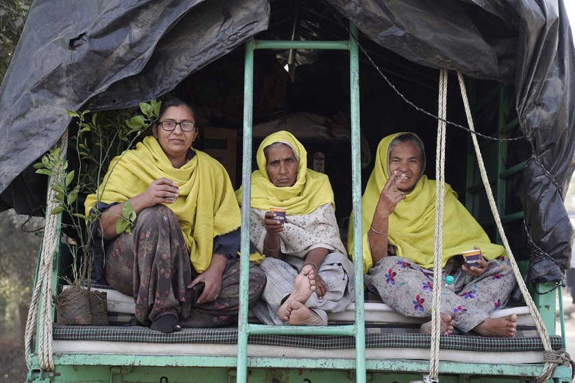 Kiranpreet Kaur, Amarjeet Kaur, and Gurmeet Kaur, all from Badhni Kalan, ready to move in a village trolley. 'We have only slept for an hour. Since yesterday we have been packing. There was a victory celebration till 3 a.m.', said Kiranpreet.