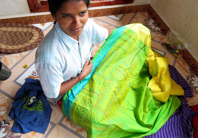 Woman showing one of her works