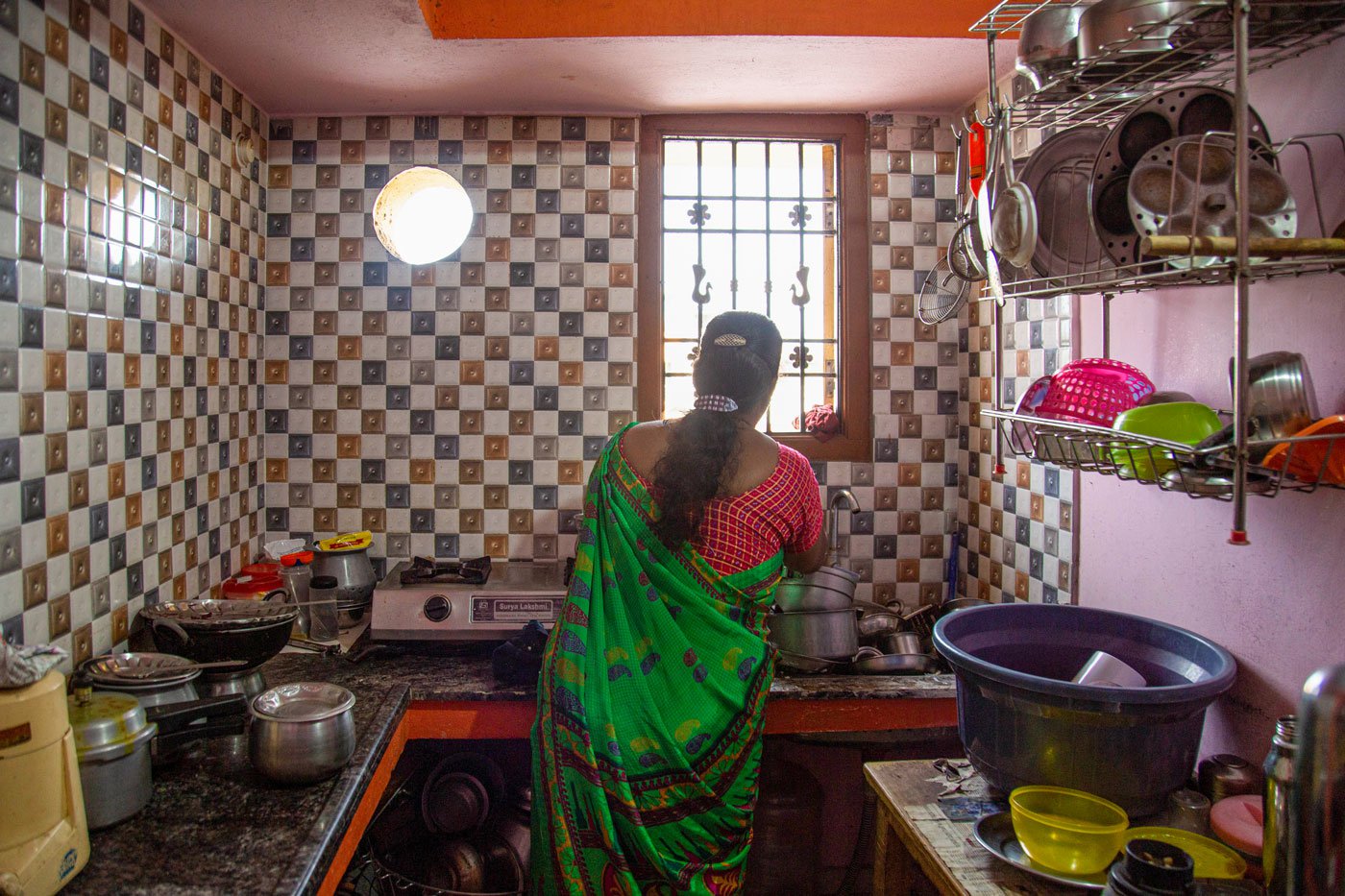 Saranya begins her day at 4 a.m. She must finish household chores before she wakes up her children and gets them ready for school