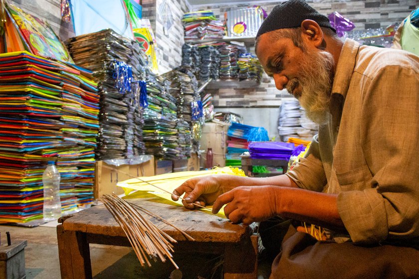 At his shop in Ahmedabad's Jamalpur area, Jameel Ahmed fixes the kamman (cross par) onto kites