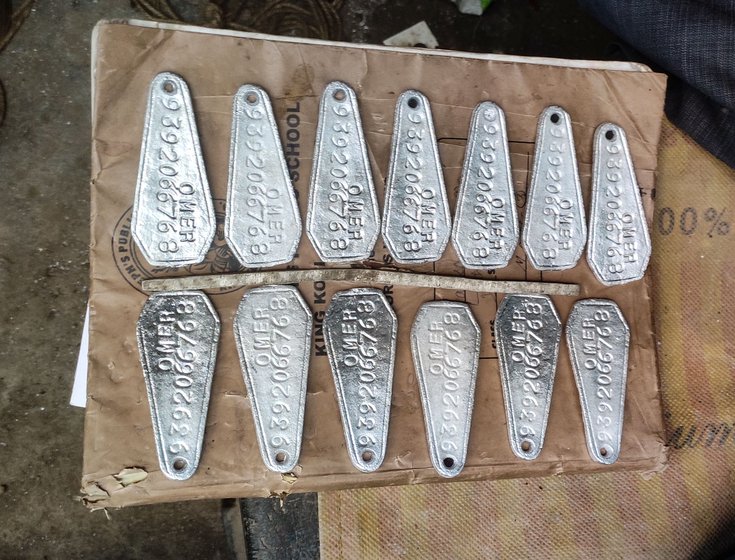 Left: Punching the letters on the token. Centre: One set of an order of 1,000 tokens that was not picked by a customer. Right: Azeem shows us how a batch of the tokens will be arranged inside the peti