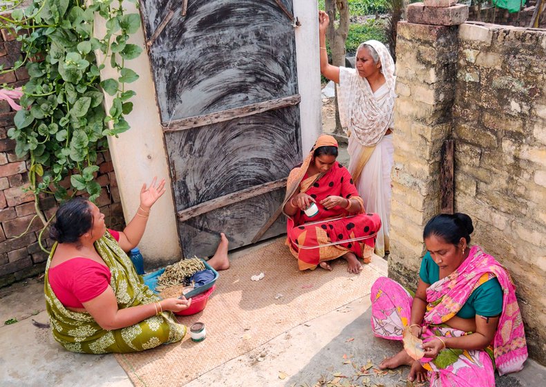 Saida Bewa at the door of the home of  beedi workers in Majhpara mohalla, Beldanga where she is speaking to them about their health