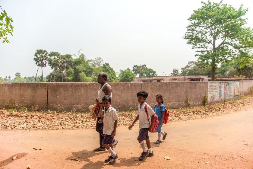 Madhav Malik returning home from school with his sons, Debashish and Manoj