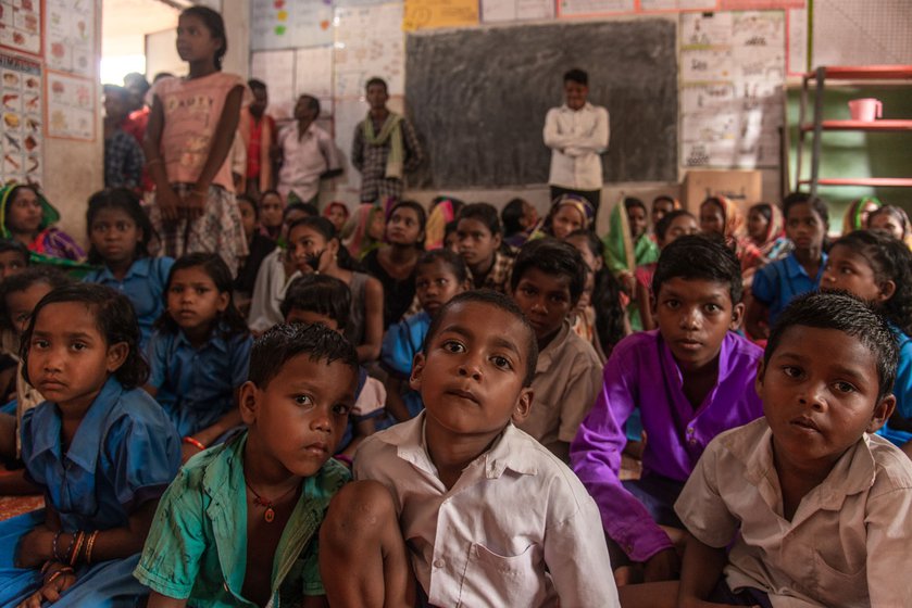 Surjaprakash Naik and Om Dehuri (both in white shirts) are from Gunduchipasi where the school was shut in 2020. They now walk to the neighbouring village of Kharadi to attend primary school.