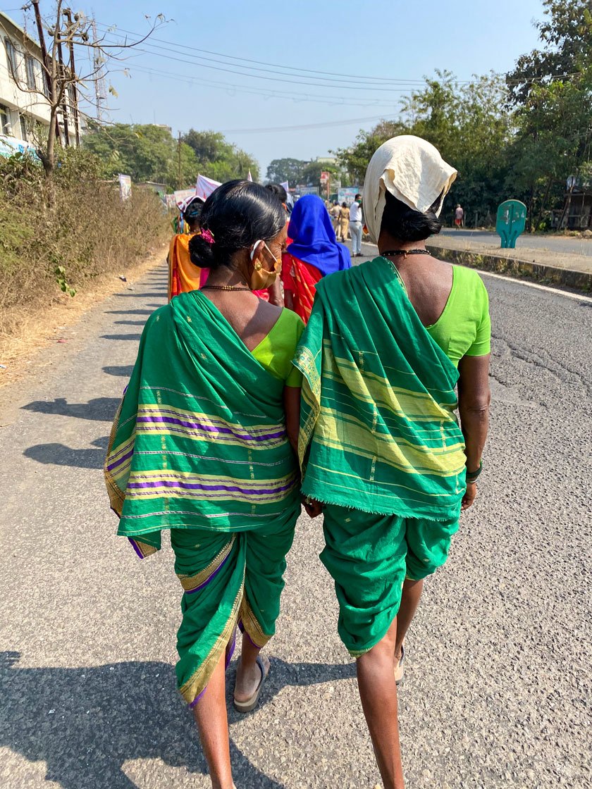 Left: Sukhi Wagh, a construction labourer, carries her three-year-old grandson Sainath on her shoulder as they march towards Khandeshwari Naka for the rasta roko protest. 'Give us rations, we have no work', she said. Right: Protestors walking towards Khandeshwari Naka

