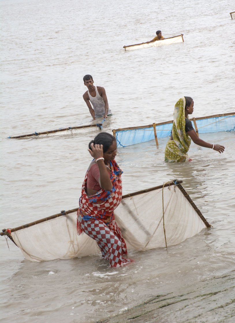 Left: Trying to make a living by catching fish in Bidya river in Amtali village. Right: Dhananjoy Bhuniya returning home to Sitarampur from Nayachar island 

