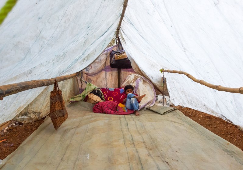 Avinash with his mobile phone in the tent