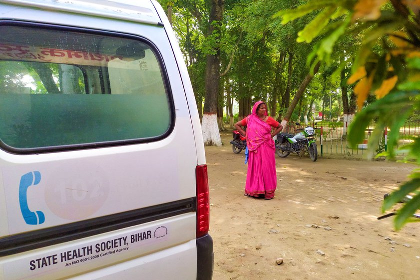 Sukhiya (who suffers from filariasis) waits for Kusum and her grandchild, who have been taken inside the vaccination room