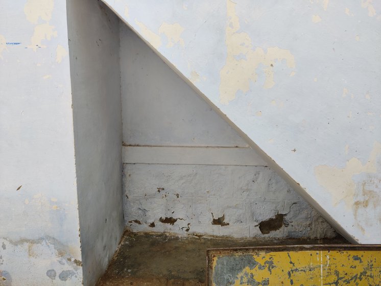 Left: The small, ramshackle muttuthurai in Saptur Alagapuri is located in an isolated spot. Rather than stay here, women prefer camping on the streets when they are menstruating. Right: The space beneath the stairs where Karpagam stays when she menstruates during her visits to the village