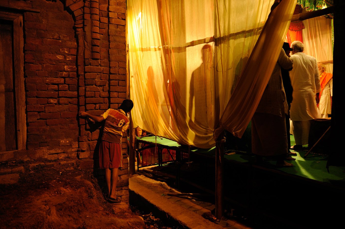 A boy is trying to peek through the back stage