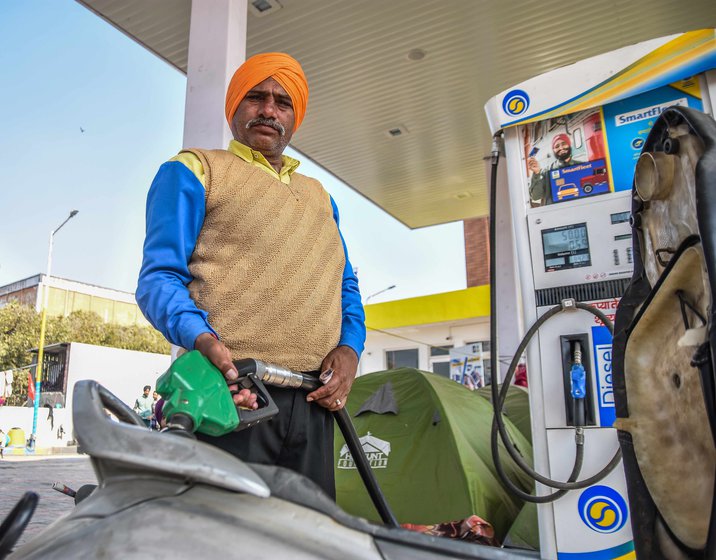 Ramdari Sharma, who works at a petrol pump near the Singhu site, asserts that his support for the protesting farmers is for a better future for the country. Right: Deepak's socks' sales have been hit, but he says, 'Don't think that I won't support the farmers. Their problems are much greater than my own'