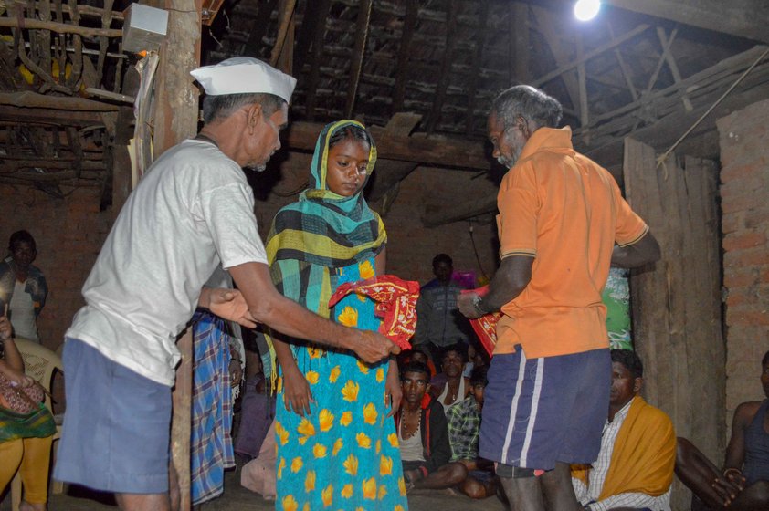 Kalu Jangali (left, in a white vest)  had confirmed the diagnosis – Nirmala (centre) had jaundice. But, he said, 'She was also heavily under the spell of an external entity', which he was warding off along with fellow bhagat Jaitya Digha during the jagran ceremony in Chikanpada hamlet