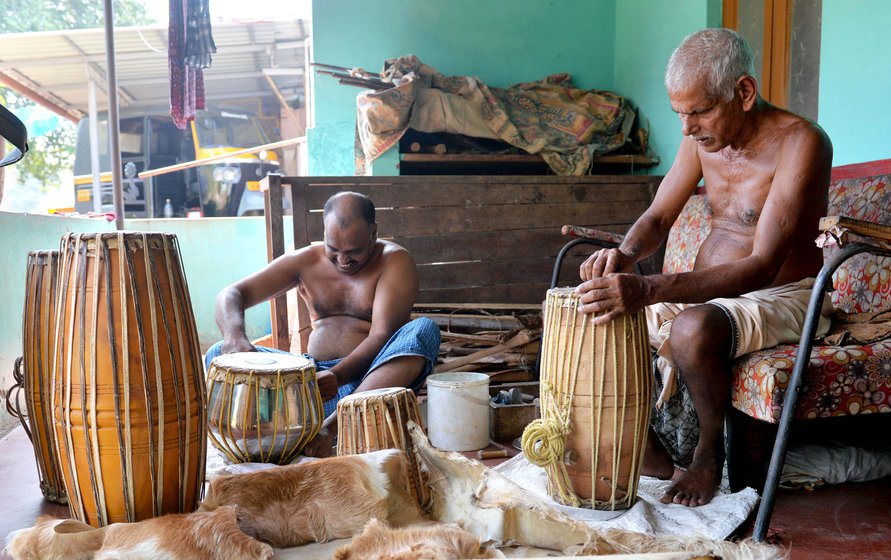 Left: The men of a family work together at home. Right: Applying the black paste on a drumhead requires precision