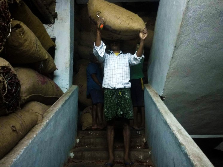 A man with sack of mirchi on his head