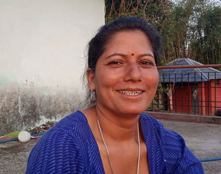 Indira Devi sitting outside her house