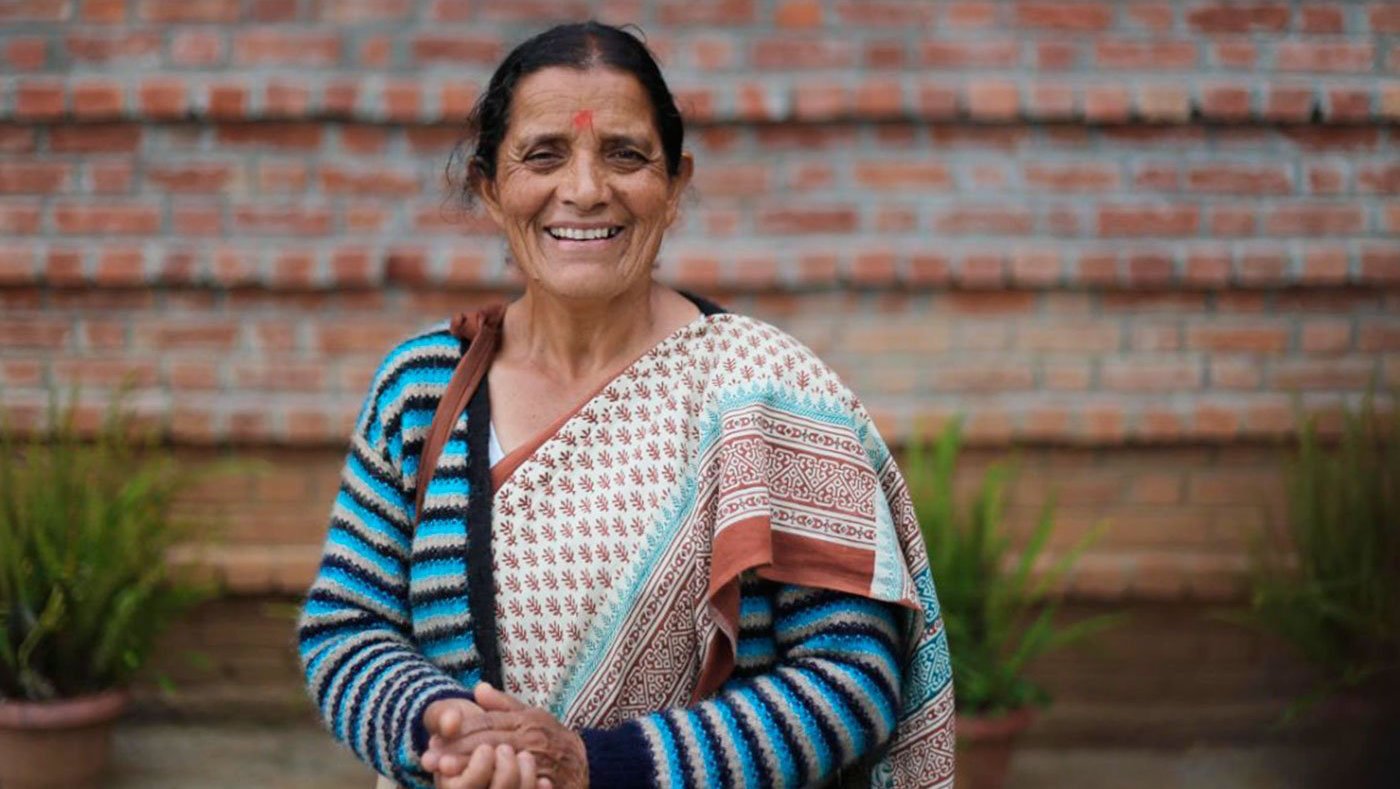 Smiling woman standing in garden