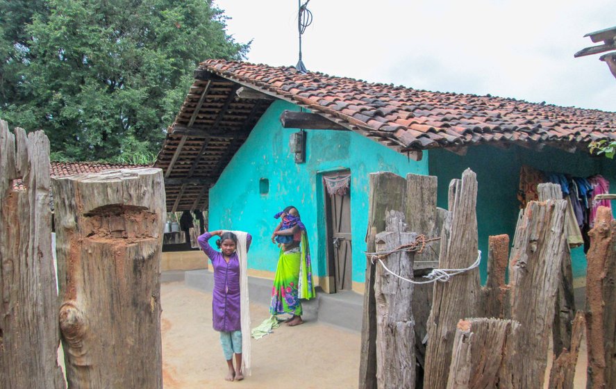 Gangay Sodhi (left) and her 13-year-old daughter Jyoti (right) at the entrance to their house