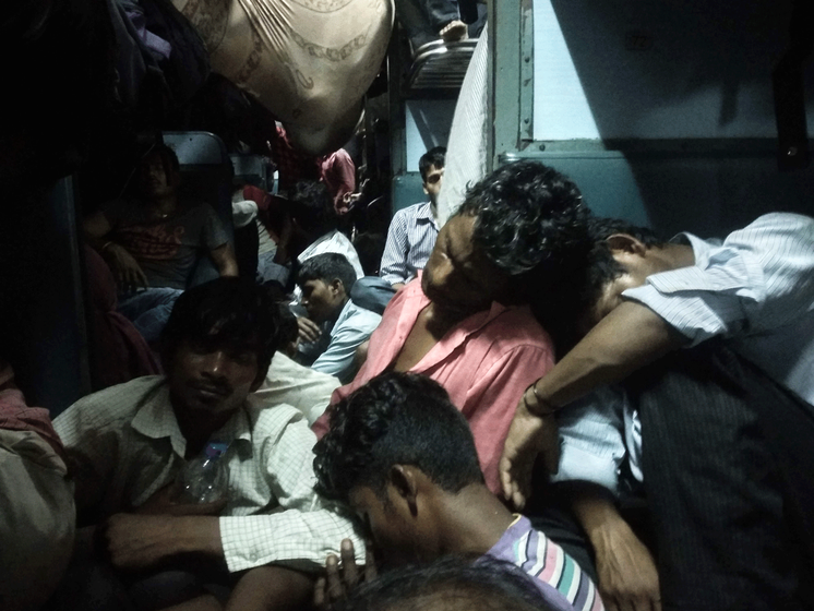 Men sleeping in train.