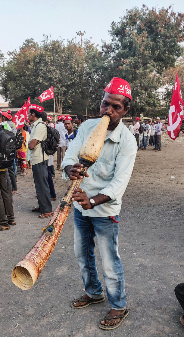 Sonya Malkari, 50, a Warli Adivasi, was playing the traditional tarpa.
