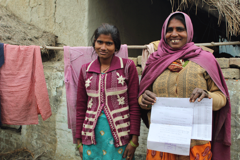 Mula (with daughter Kapoora) holding the application she gave to the block office to inquire about her missing wages